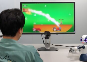 A robot capable of playing video games with humans