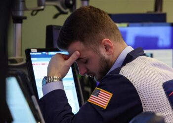 Wall Street sees red, while the economy resists