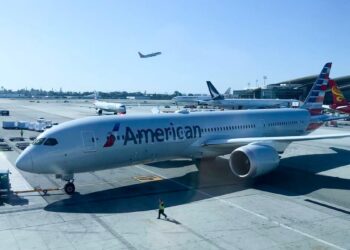 A passenger tries to open the door of a plane in mid-flight