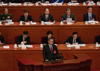 China sets a 5% growth target and pledges to adjust its economic model