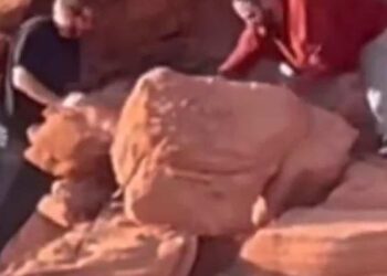 Two visitors damage ancient rock formations at a protected site