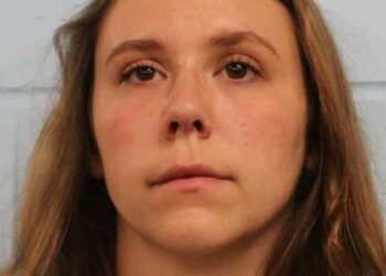 A teacher moves her 11-year-old student’s desk so she can massage his legs