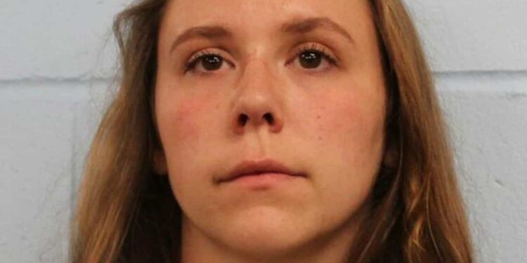 A teacher moves her 11-year-old student’s desk so she can massage his legs