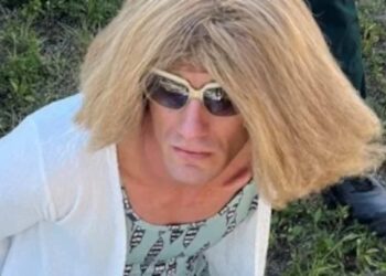 He steals a boat and disguises himself as a woman to escape the police