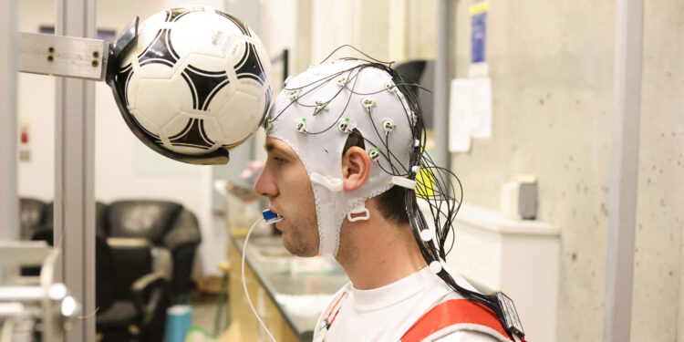 Heading in football briefly slows brain activity, study finds