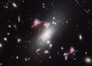 Webb Reveals Distorted Cosmic Question Mark About Galaxy Formation
