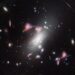 Webb Reveals Distorted Cosmic Question Mark About Galaxy Formation