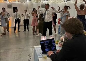 Groom causes controversy by working on his computer during his reception