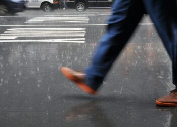 Walk or run in the rain? A physics-based approach to staying dry (or at least drier)