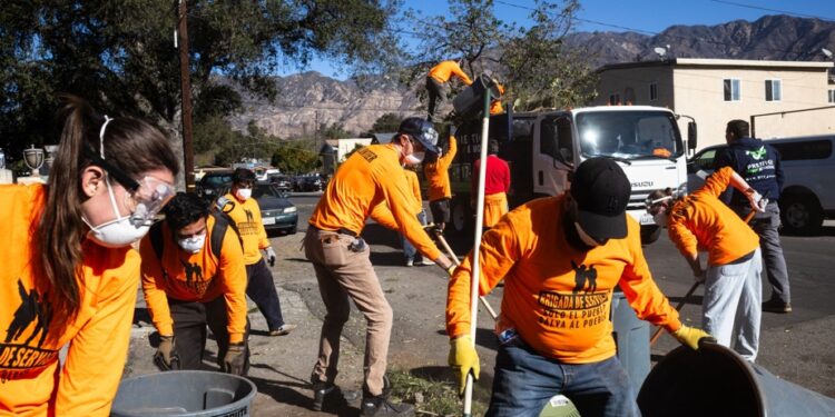 Fires in Los Angeles | Volunteers clean streets littered with charred debris