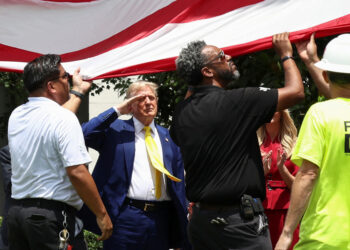 Donald Trump raises a giant flag in the White House